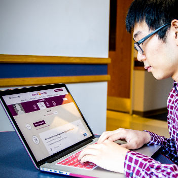 Haiwei Ma viewing CaringBridge on a laptop